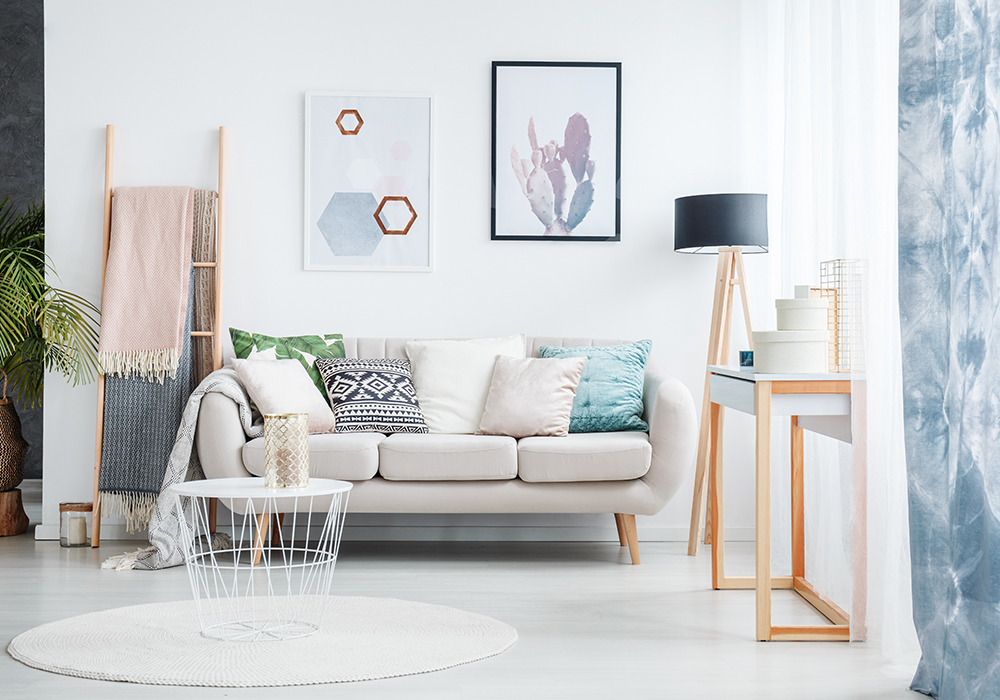 Staged living room with white rug, small table, and sofa