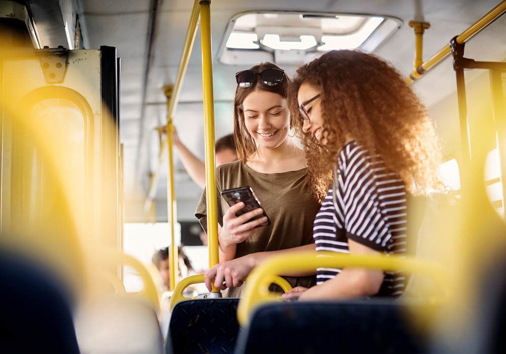Two girls using public transportation on Car Free Day