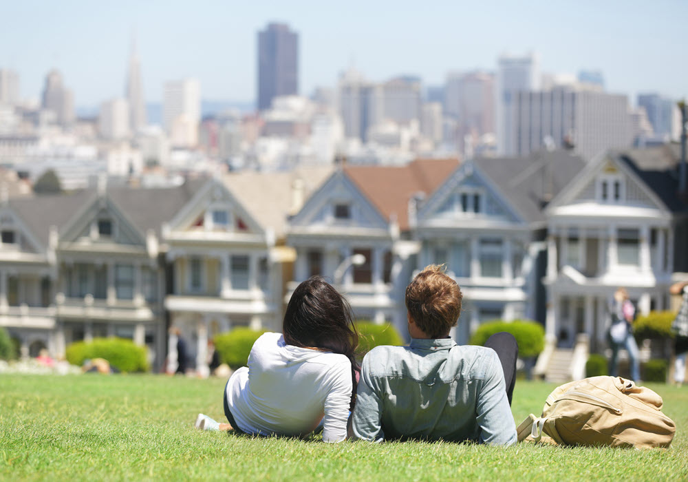 Couple at park looking at The Painted Ladies in San Francisco.