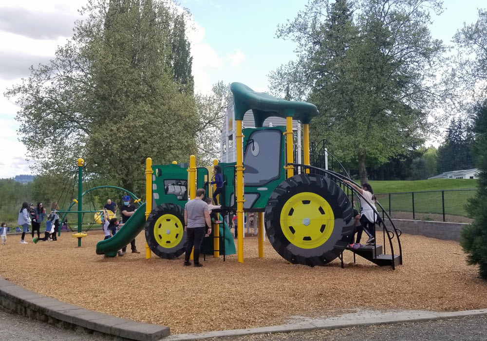 Kelsey Creek Park featuring tractor-shaped playground.