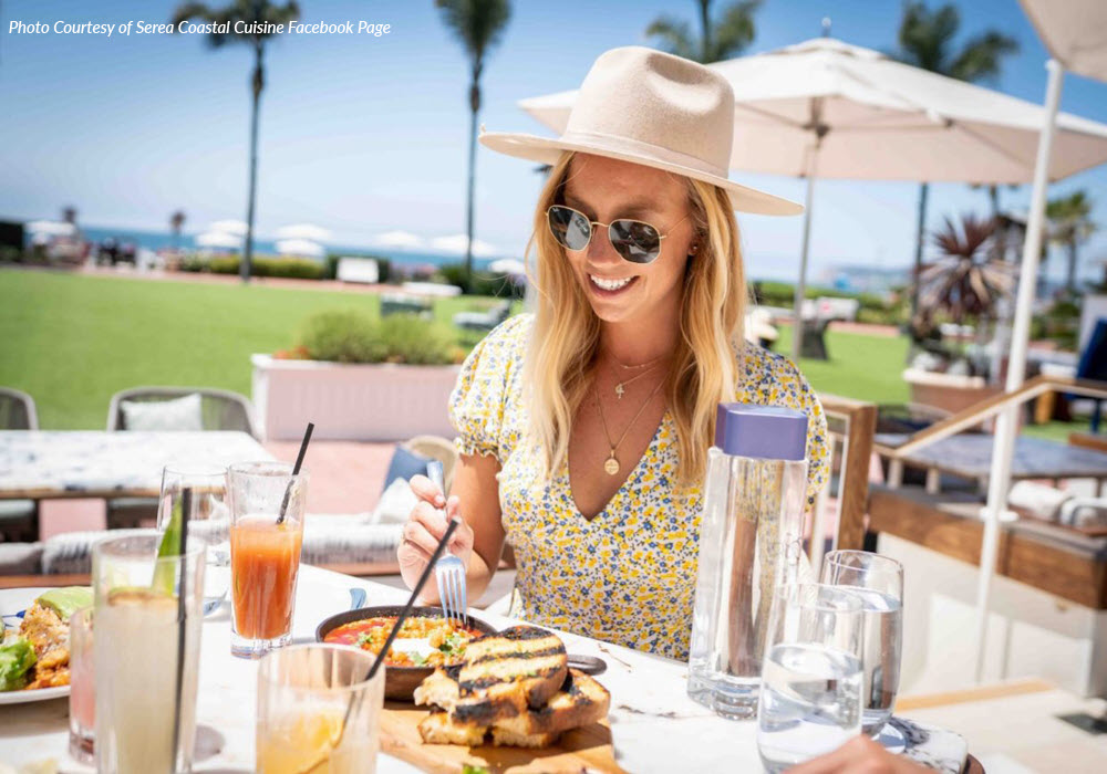 Woman eating at Serea Coastal Cuisine in San Diego.