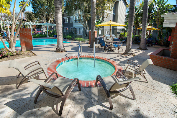 Outdoor spa and swimming pool area with lounge seating.