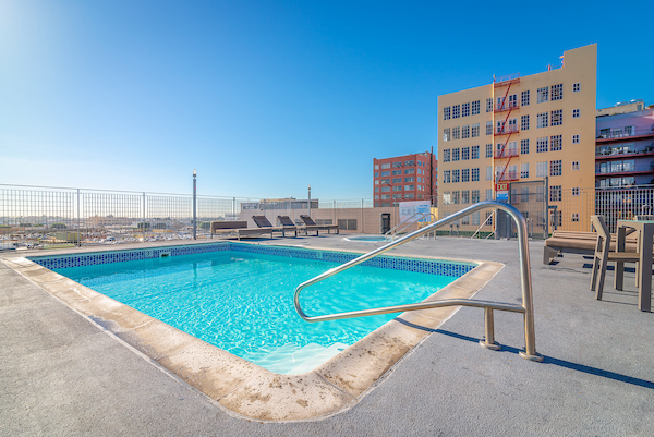 Rooftop spa and swimming pool area with sundeck and lounge seating.