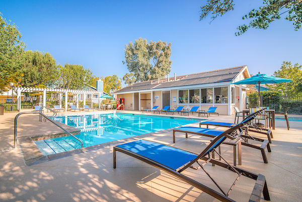 Outdoor swimming pool area with lounge seating.